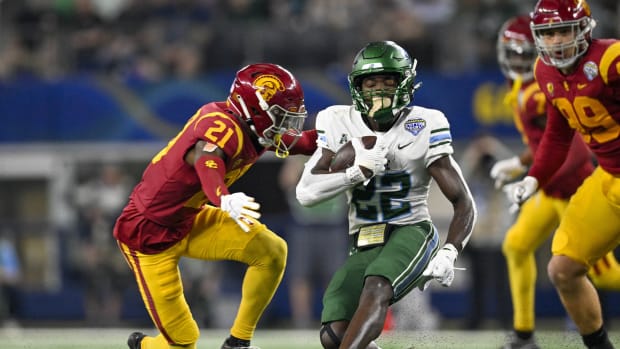 Jan 2, 2023; Arlington, Texas, USA; Tulane Green Wave running back Tyjae Spears (22) attempts to elude the tackle of USC Trojans defensive back Latrell McCutchin (21) during the first half in the 2023 Cotton Bowl at AT&T Stadium. Mandatory Credit: Jerome Miron-USA TODAY Sports